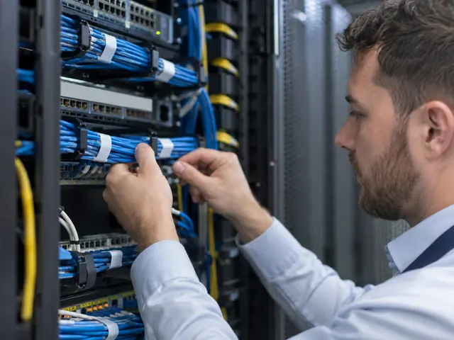 Technician inspecting network cabling during planned maintenance
